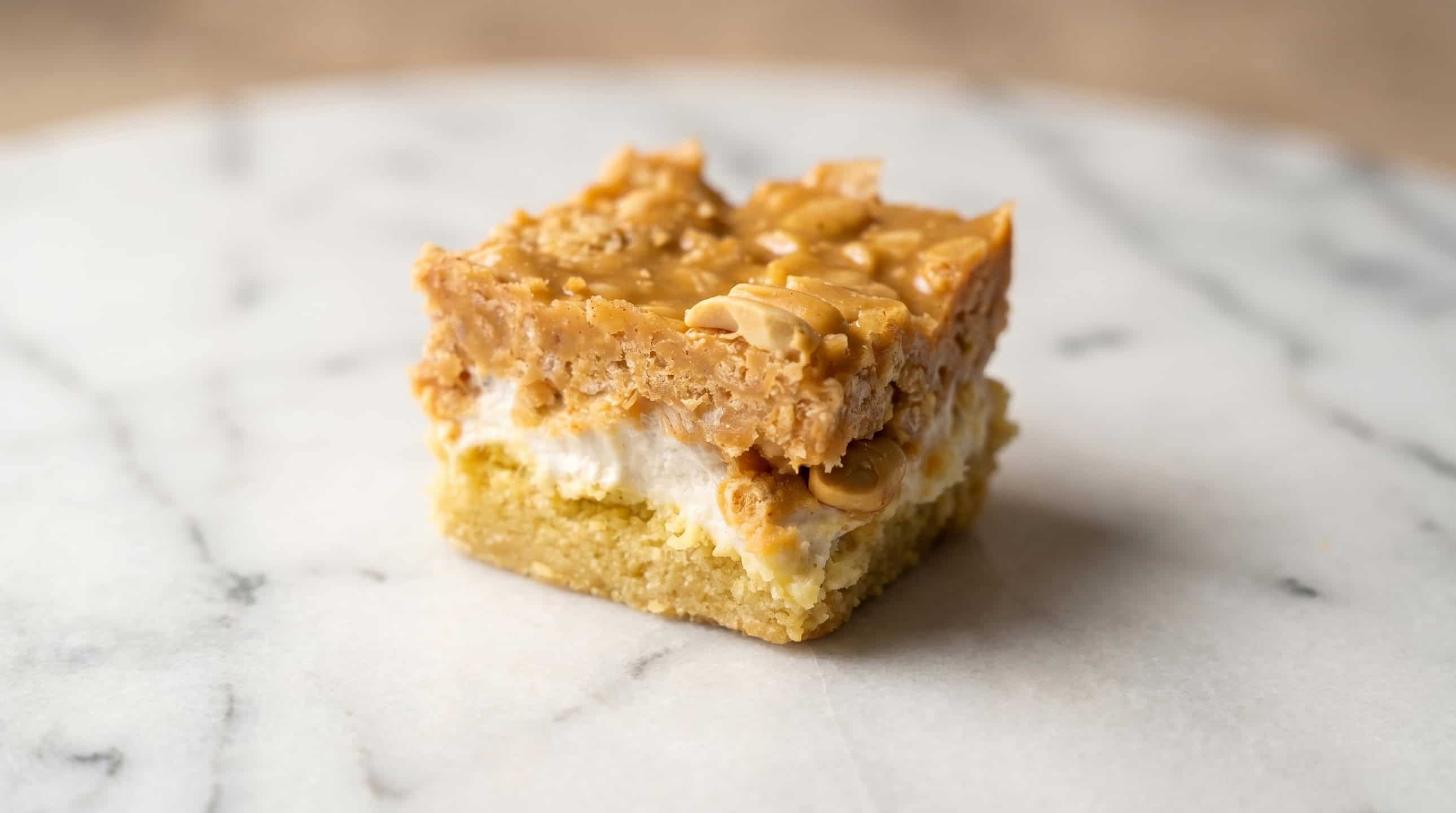 Salted nut roll bars topped with chopped peanuts